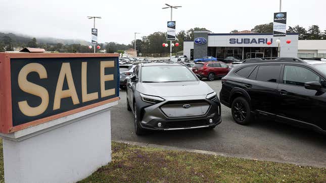 A photo of new cars on the lot at a Subaru dealer. 