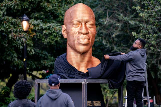 In this Thursday, Sept. 30, 2021, file photo, a sculpture of George Floyd, one of three sculptures as part of the “SEEINJUSTICE” art exhibition that also feature the likenesses of Breonna Taylor and John Lewis, is unveiled as Floyd’s brother Terrence, second from left, looks at Union Square in the Manhattan borough of New York. The statue honoring Floyd was vandalized on Sunday, Oct. 3, police said. 