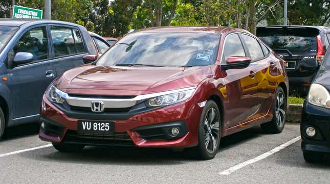 A red 2017 Honda Civic sedan in a parking lot