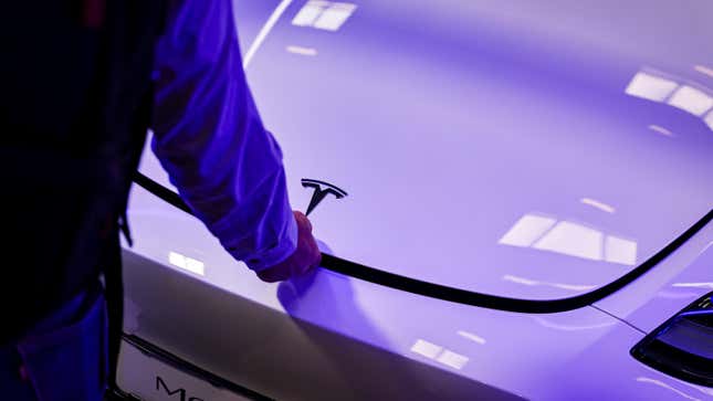 Visitors look at a Model Y electric car by the car brand Tesla at the IAA Mobility 2023 international motor show on September 6, 2023 in Munich, Germany