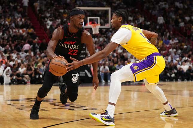 Nov 6, 2023; Miami, Florida, USA; Miami Heat forward Jimmy Butler (22) drives the ball around Los Angeles Lakers forward Cam Reddish (5) during the first half at Kaseya Center.