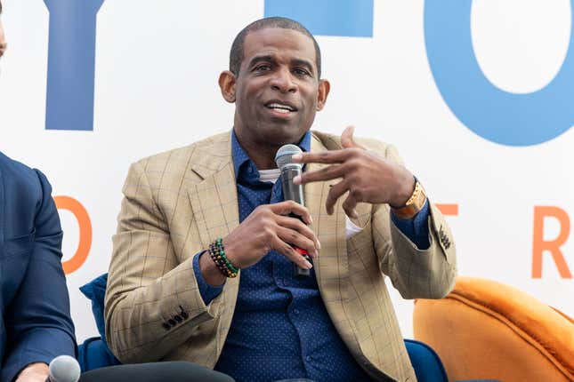 Deion Sanders speaks on stage during the 2022 International Poverty Forum at Porsche Cars North America on March 04, 2022 in Atlanta, Georgia.