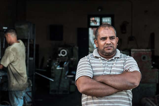 Ibrahim outside his car repair shop