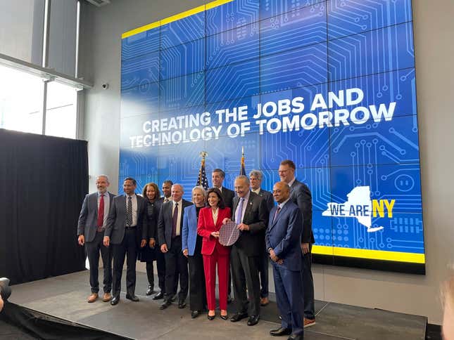 New York Gov. Kathy Hochul and Sen. Chuck Schumer hold a silicon wafer and pose for a photo with lawmakers and leaders from the semiconductor industry during an event at University at Albany in Albany, New York, Monday, Dec. 11, 2023. New York will spend $1 billion to expand research into chip technology in Albany, the state&#39;s capital, with the goal of turning the region into a global center of semiconductor research and manufacturing, Gov. Kathy Hochul announced Monday. (AP Photo/Maysoon Khan)