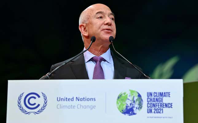Jeff Bezos talks in front of a podium with the logos of the United Nations Framework Convention on Climate Change and COP26 in Glasgow.