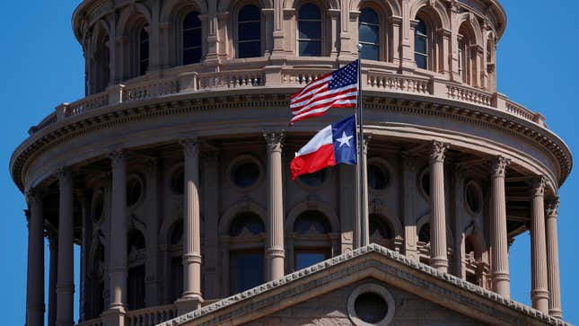 The U.S flag and the Texas State flag fly over the Texas State Capitol in Austin, Texas, U.S., March 14, 2017. 