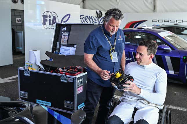 Robert Wickens showing his steering wheel to Michael Andretti