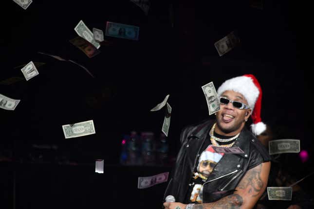 Flo Rida lanza billetes de un dólar mientras actúa en el escenario durante el Jingle Ball 2022 de iHeartRadio 93.3 FLZ presentado por Capital One en el Amalie Arena en diciembre 16, 2022 en Tampa, Florida