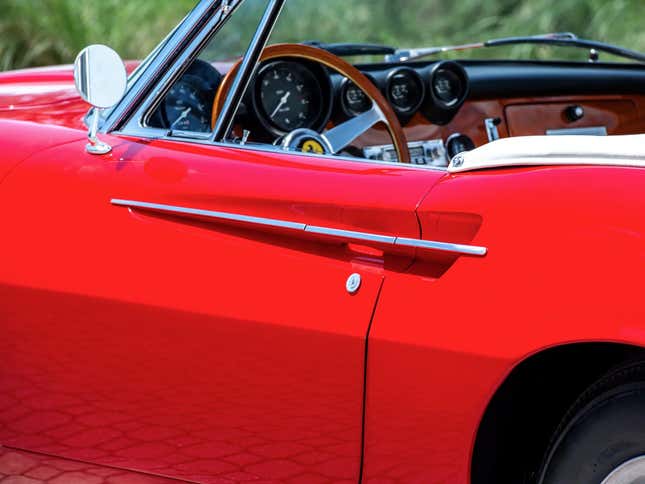 Door handle of a red 1967 Ferrari 365 California Spyder