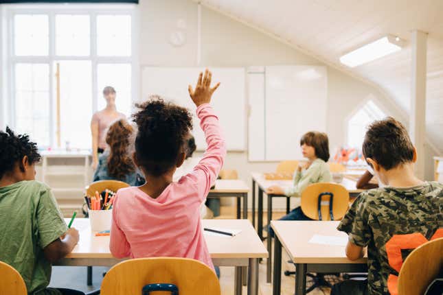 Black Kid Raising Hand in Classroom 