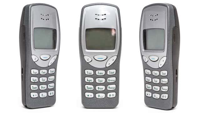 Three Nokia 3210s in a row showing blank screens