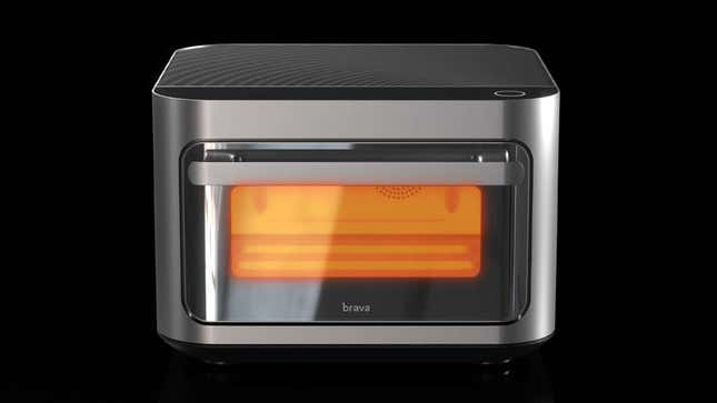 The Brava Glass smart oven with the visible interior glowing orange against a black background.
