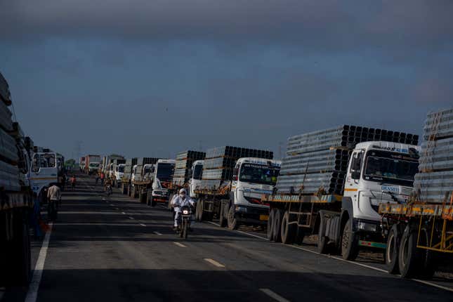 FILE - Trucks carry aluminum alloy frames to Adani Green Energy Limited&#39;s Renewable Energy Park near Khavda, Bhuj district near the India-Pakistan border in the western state of Gujarat, India, Sept. 21, 2023. (AP Photo/Rafiq Maqbool, File)