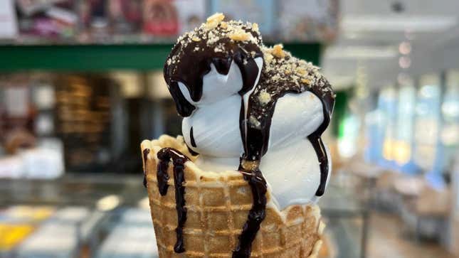 Krispy Kreme Doughnut Soft Serve ice cream cone with chocolate drizzle