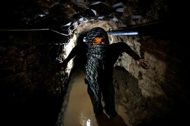 A Palestinian works inside a smuggling tunnel flooded by Egyptian forces, beneath the Egyptian-Gaza border in Rafah, in the southern Gaza Strip February 19, 2013.