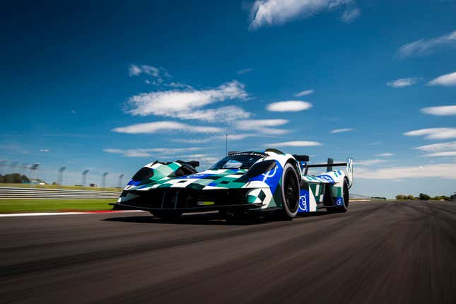 Camouflaged Aston Martin Valkyrie driving on a race track