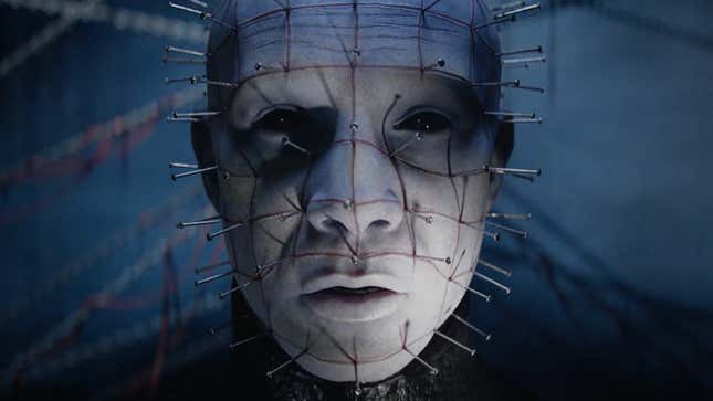 A guy with lots of nails in his face appears on screen.