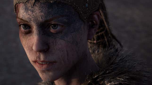 Hellblade's Senua stares to the left, with dirl all over her face.