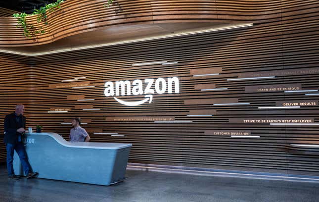 Two Amazon employees talk at one of the entrances to the new Amazon headquarters in Arlington, Virginia. 