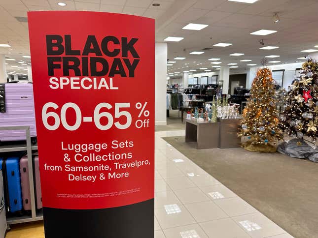 A sign announces Black Friday specials on luggage sets inside a Macy&#39;s department store on Monday, Nov. 20, 2023, in Denver. Retailers are kicking off the unofficial start of the holiday shopping season on Friday with a bevy of discounts and other enticements. (AP Photo/David Zalubowski)