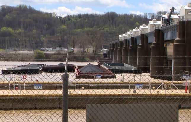 A group of barges sit pinned against the Emsworth lock and dam in Pittsburgh, on Saturday, April 13, 2024. More than two dozen river barges broke loose from their moorings and floated down the Ohio River, damaging a marina and striking a bridge. (WTAE via AP)