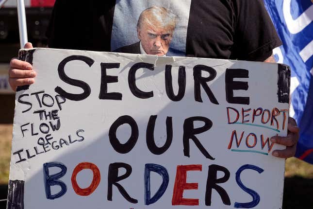 FILE - Phill Cady holds a sign during a &quot;Take Our Border Back&quot; rally on Feb. 3, 2024, in Quemado, Texas. Online actors tied to the Kremlin have begun pushing misleading and incendiary claims about U.S. immigration in an apparent bid to target American voters ahead of the 2024 election. (AP Photo/Eric Gay)