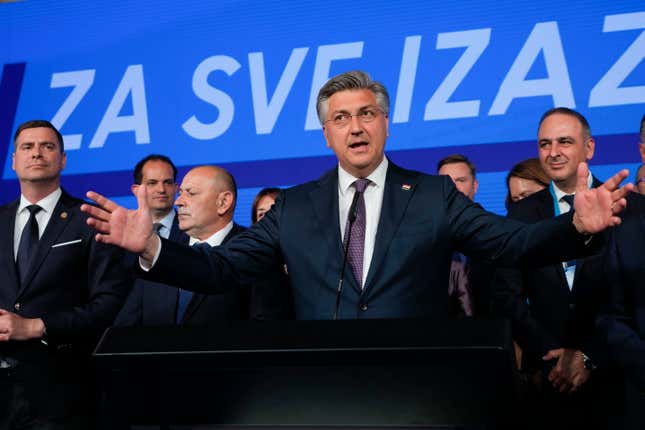 Prime Minister incumbent Andrej Plenkovic, center, speaks after claiming victory in a parliamentary election in Zagreb, Croatia, Thursday, April 18, 2024. Croatia&#39;s governing conservatives convincingly won a highly contested parliamentary election Wednesday, but will still need support from far-right groups to stay in power, according to the official vote count. The election followed a campaign that centered on a bitter rivalry between the country&#39;s president and prime minister. (AP Photo/Darko Vojinovic)