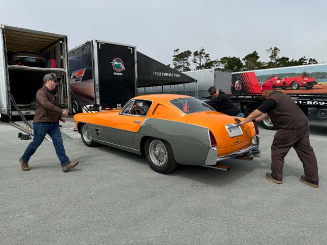 Rear 3/4 view of an orange and grey 1954 Ferrari 375 MM Ghia Coupe