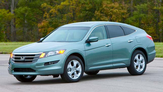 A photo of a blue Honda Crosstour sedan in a parking lot. 