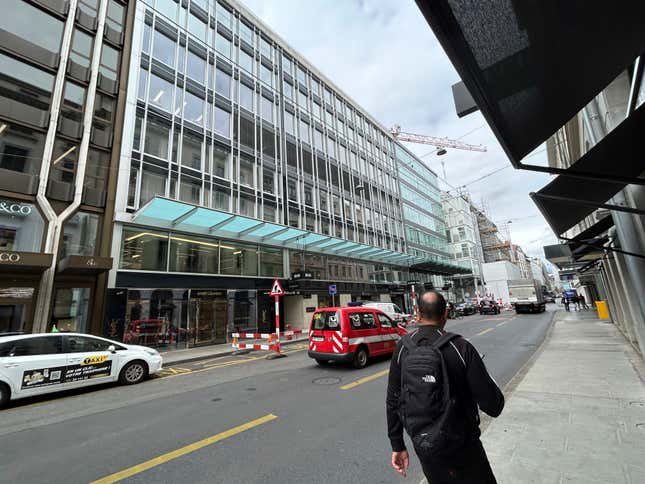 FILE - A man walks past the building where is located the Gunvor trading office in Geneva, Switzerland, Wednesday July 26, 2023. Geneva-based commodities trading firm Gunvor said Friday, March 1, 2024, that it has reached a $661 million settlement with U.S. and Swiss prosecutors after convictions for bribery of foreign officials in connection with the petroleum industry in Ecuador. (AP Photo/Jamey Keaten, File)