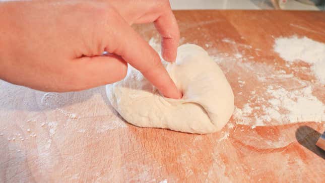 Bread dough on a floured counter top.