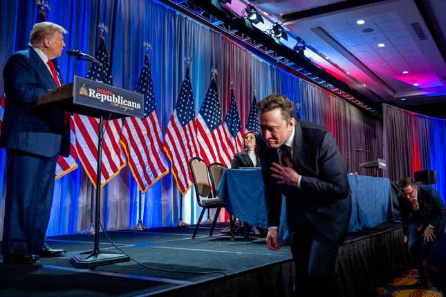 President-elect Donald Trump addresses House Republicans as Tesla and SpaceX CEO Elon Musk rishes past the stage. 