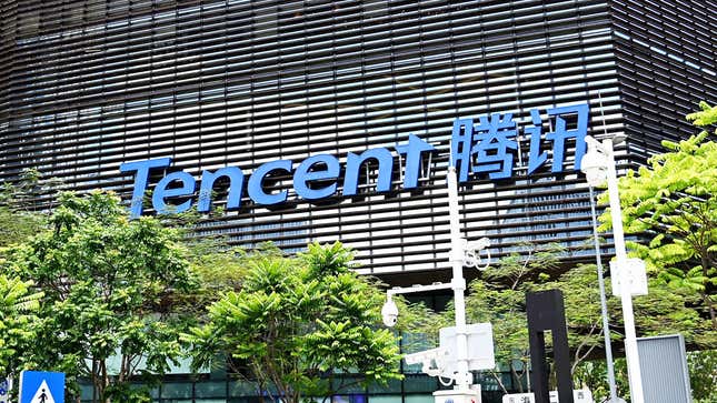 A large, blue Tencent sign on the fa?ade of an office building.