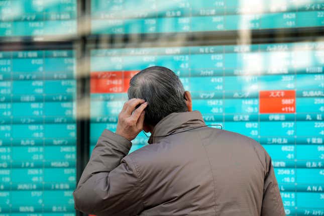 FILE - A person looks at an electronic stock board showing Japan&#39;s stocks&#39; prices at a securities firm in Tokyo, Dec. 21, 2023. Asian shares powered higher on Thursday, Dec. 28 with Chinese benchmarks up more than 1%, after Wall Street logged modest gains in this holiday-shortened week. (AP Photo/Eugene Hoshiko, File)