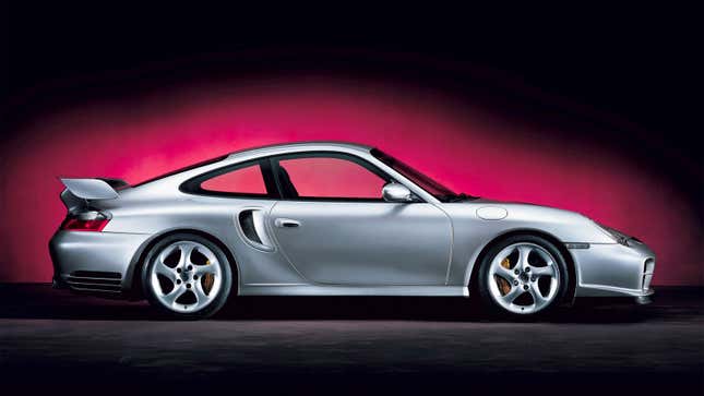 A photo of a silver Porsche 911 taken in a studio. 