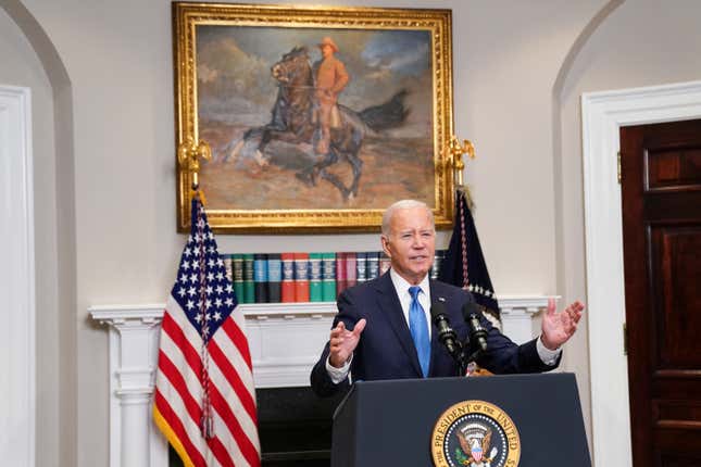 US president Joe Biden gestures while speaking at a podium in the White House.