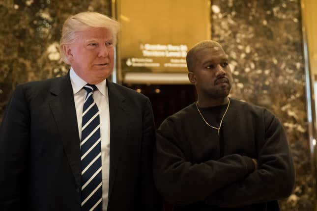 Then-President-elect Donald Trump and Kanye West stand together in the lobby at Trump Tower, December 13, 2016 in New York City.