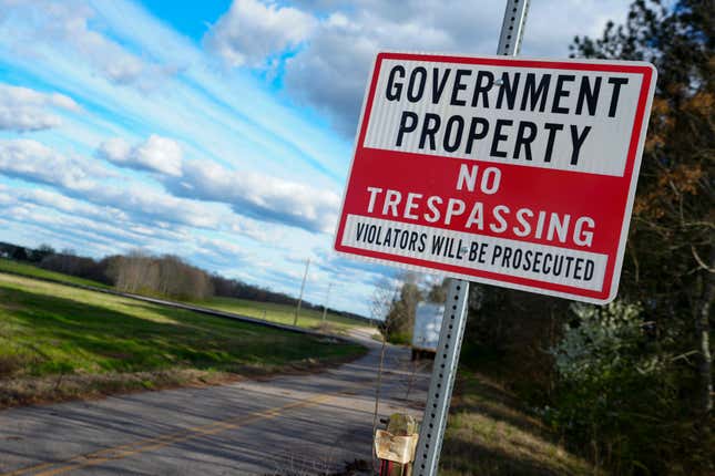 A sign warns against trespassing on government property at the site of a planned Rivian electric truck plant Thursday, March 7, 2024, in Rutledge,Ga. Rivian says it&#39;s pausing construction of the $5 billion manufacturing plant in Georgia. (AP Photo/John Bazemore)