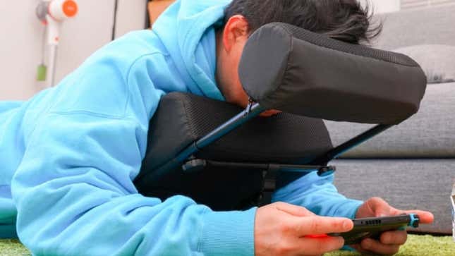 A man uses the gaming cushion. 