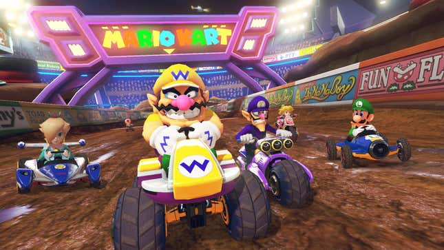 Wario smiling while racing in Mario Kart 8 Deluxe.