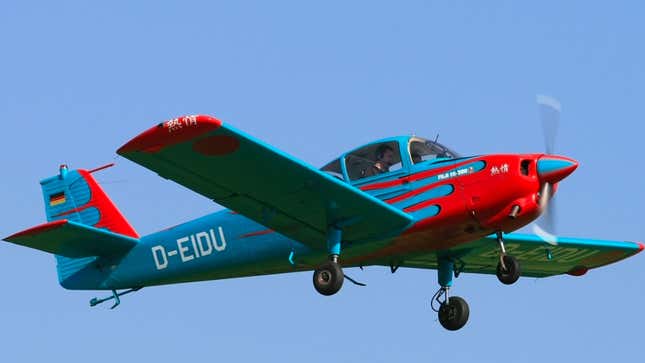 A photo of a blue Subaru plane flying. 