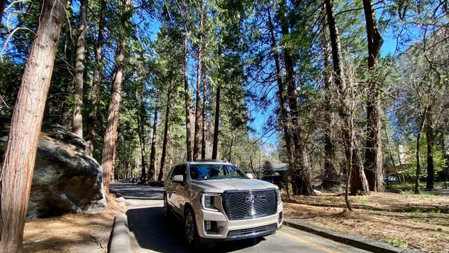 A photo of my beige Yukon Denali parked among the giant trees in Yosemite National Park