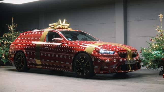 Front 3/4 view of a BMW M5 Touring with a Christmas wrap
