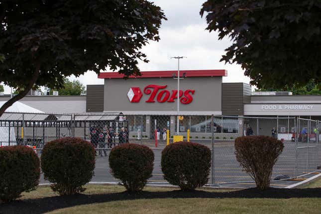 People stand in the parking lot of the Tops Friendly Market on Thursday, July 14, 2022, in Buffalo, N.Y.