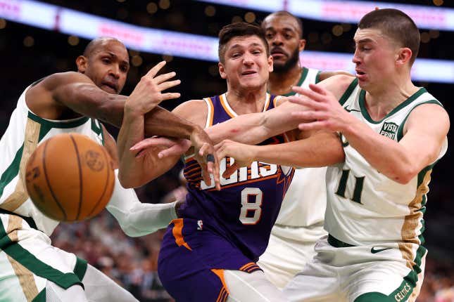 BOSTON, MASSACHUSETTS - MARCH 14: Grayson Allen #8 of the Phoenix Suns, Payton Pritchard #11 of the Boston Celtics and Al Horford #42 battle for a loose ball during the second quarter at TD Garden on March 14, 2024 in Boston, Massachusetts. NOTE TO USER: User expressly acknowledges and agrees that, by downloading and or using this photograph, user is consenting to the terms and conditions of the Getty Images License Agreement.  (Photo by Maddie Meyer/Getty Images)