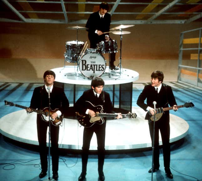 FILE -The Beatles, foreground from left, Paul McCartney, George Harrison, John Lennon and Ringo Starr on drums perform on the CBS &quot;Ed Sullivan Show&quot; in New York on Feb. 9, 1964. Sixty years after the onset of Beatlemania and with two of the quartet now dead, artificial intelligence has enabled the release of a “new” Beatles song.“Now And Then,” will be available Thursday, Nov. 2. (AP Photo/File)