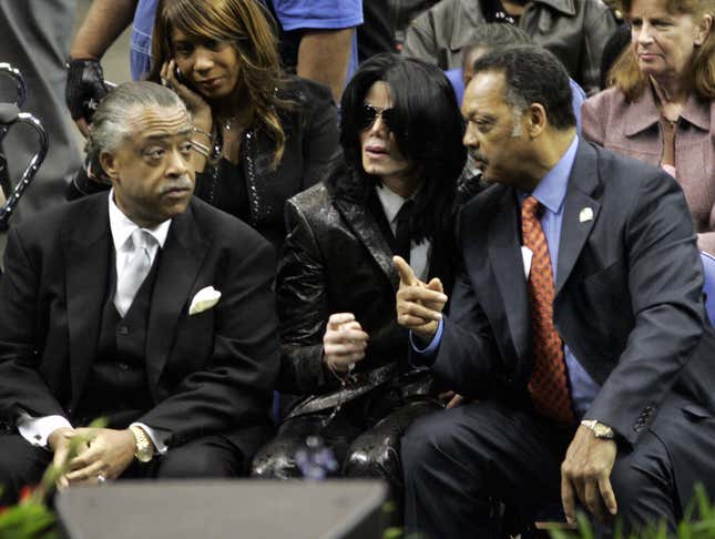  In this file photo Michael Jackson sits with the Reverends Jessie Jackson (R) and Al Sharpton (L) at the funeral of James Brown December 30 2006,