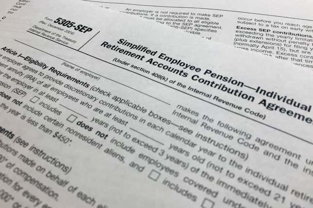 FILE - In this April 2, 2018, file photo, an IRS Form 5305, Simplified Employee Pension — Individual Retirement Accounts Contribution Agreement is shown in New York. Companies have long helped their workers save for retirement through 401(k)s and other workplace plans. But recent SECURE 2.0 legislation has blessed a newer trend: employers creating emergency savings options that could encourage workers to save more and avoid raiding their retirement funds. (AP Photo/Jenny Kane, File)