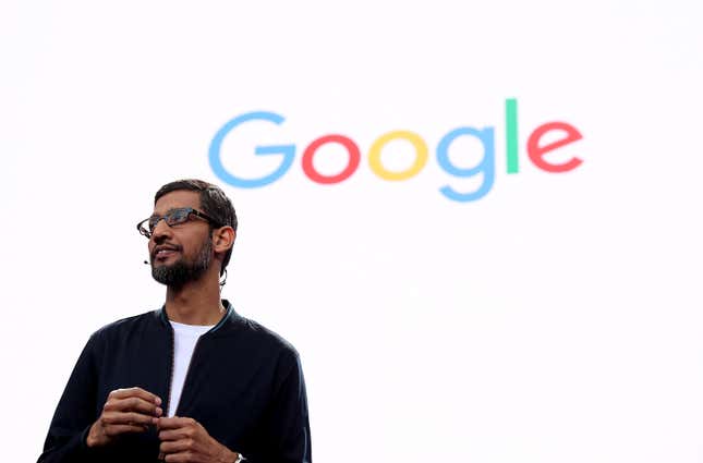 Sundar Pichai standing in front of a screen that says Google