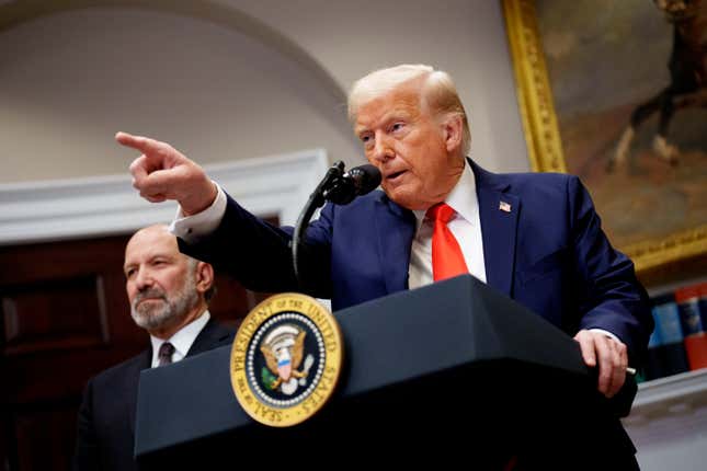 U.S. President Donald Trump, accompanied by Commerce Secretary Howard Lutnick (L) takes a question from a reporter in the Roosevelt Room of the White House on March 3, 2025 in Washington, DC.